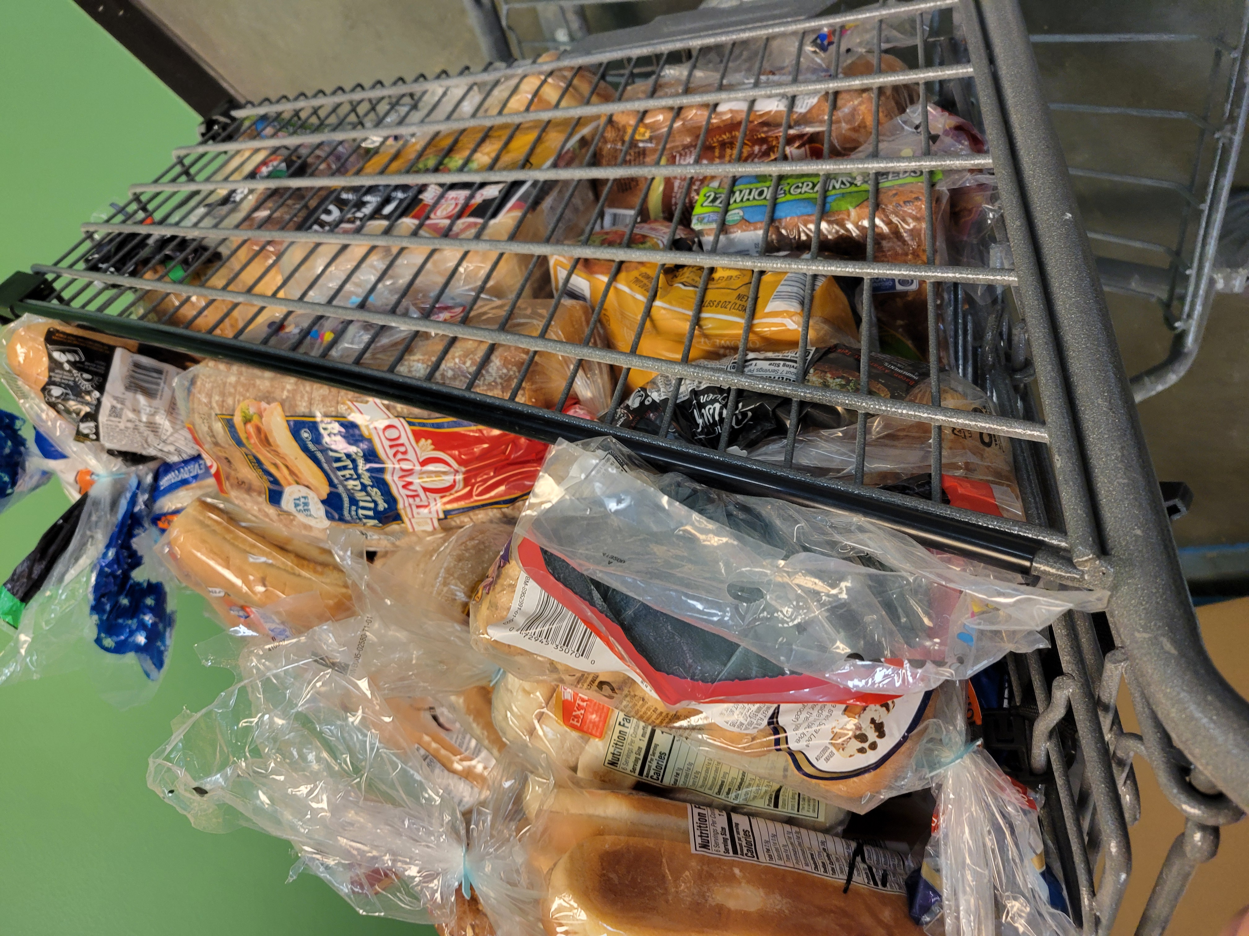 Shopping cart full of various breads.